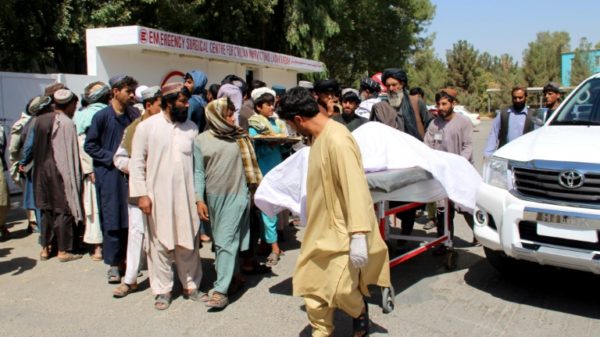 Afghan villagers moving a dead body following an airstrike in Lashkar Gah, Helmand province, in September 2019 that allegedly killed 40 civilians at a wedding celebration.