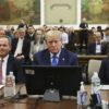 Former US president Donald Trump sits with his attorneys during the opening day of a civil fraud case brought by New York Attorney General Letitia James