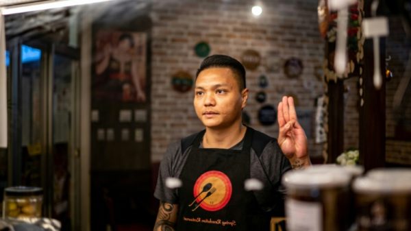 Refugee goalkeeper Pyae Lyan Aung flashed the three-fingered gesture, a popular protest symbol, as his team lined up to face Japan