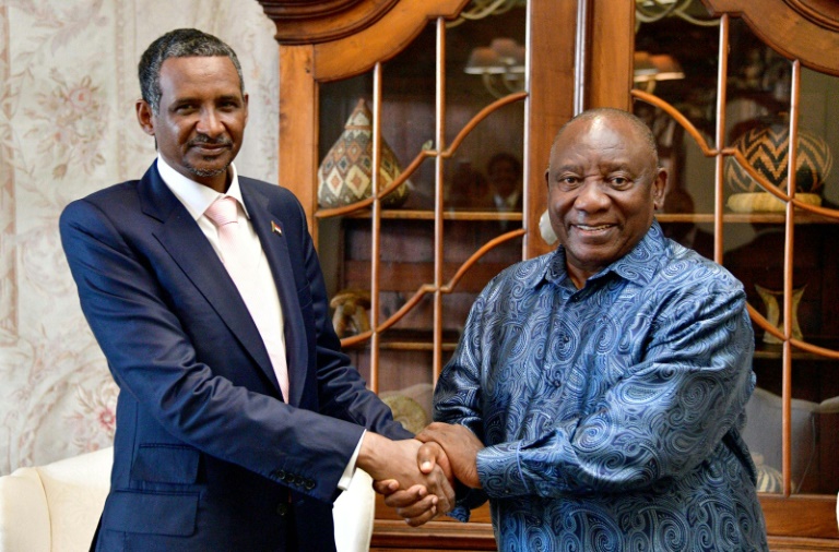 Sudan's paramilitary chief Mohamed Hamdan Daglo (L), with South African President Cyril Ramaphosa (R) in Pretoria, has been greeted as if he were a head of state, analysts say