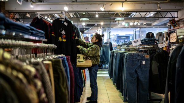 A customer visits a secondhand clothes shop in the Harajuku district of Tokyo