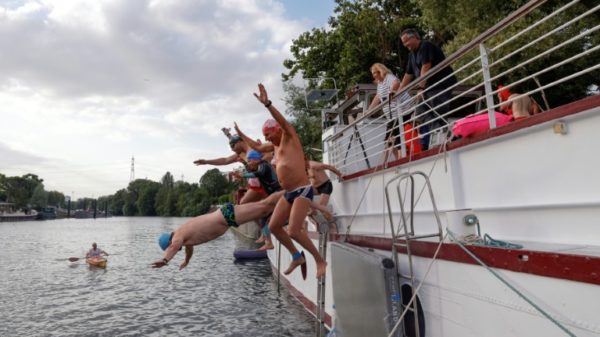 Swimmers leap into the Seine at the Ile Saint-Denis in July