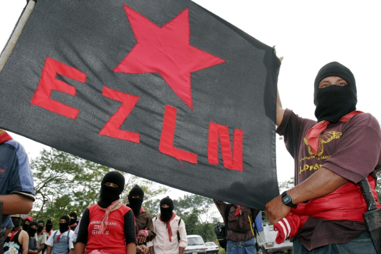 Supporters hold a banner of Mexico's Zapatista National Liberation Army (EZLN) at the Mayan archeological ruins of Palenque on January 3, 2005