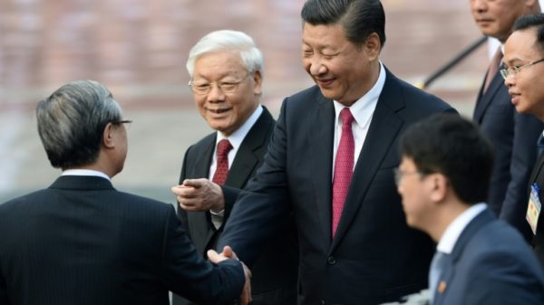 Chinese President Xi Jinping (C) will hold talks with the head of Vietnam's ruling communist party, followed by meetings with the country's prime minister and president