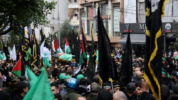 Crowds march in the Beirut funeral procession of Hamas number two Saleh al-Aruri