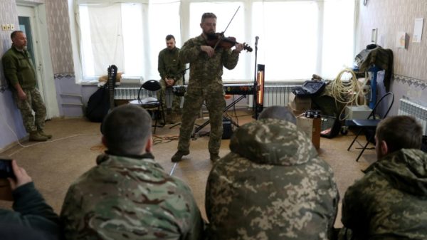 A Ukrainian Cultural Forces musician performs for recuperating soldiers at a centre in the eastern Donetsk region