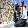 Jose Contreras, of Venezuela, knelt in prayer as migrants waited to turn themselves in for processing to US border agents in El Paso, Texas