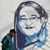 A policeman walks past a portrait of Bangladesh's Prime Minister Sheikh Hasina on Monday, a day after she won re-election for a fifth term