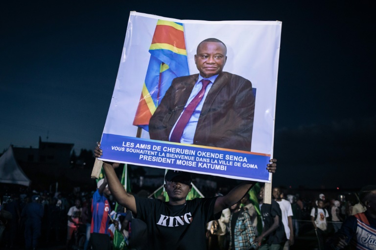 An opposition supporter at a rally in Goma last month with a poster of Cherubin Okende, who was gunned down in July