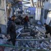 Palestinians search through the rubble of a building following an Israeli strike in the southern Gaza Strip on Tuesday