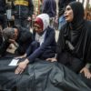 Relatives mourn over the body of a loved one killed during Israeli bombardment at Nasser Hospital in Khan Yunis