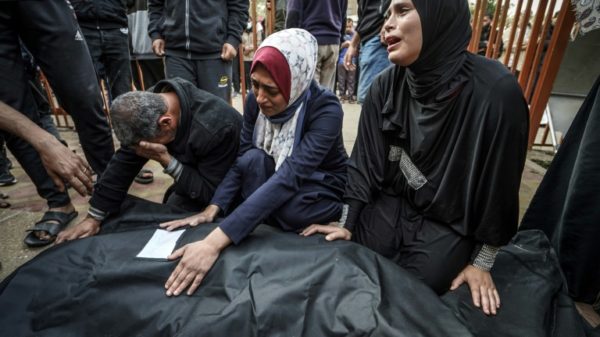 Relatives mourn over the body of a loved one killed during Israeli bombardment at Nasser Hospital in Khan Yunis