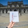 A man holds up a copy of Chile's proposed new Constitution in front of La Moneda Presidential Palace