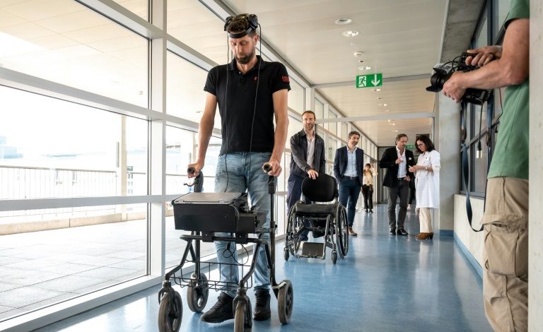 Gert-Jan, who is paralysed, walks using new technology that decodes his brain's signals