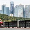 A woman pushes a pram in front Moscow's International Business Centre