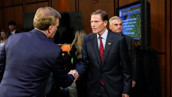 US Senator Richard Blumenthal shakes hands with Chief Operating Officer of the PGA Tour Ron Price during a Senate subcommittee hearing examining the business deal between the PGA Tour and the Public Investment Fund of Saudi Arabia, backers of LIV Golf