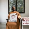 Baba Hydara holds a poster of his late father Deyda Hydara who was gunned down in 2004