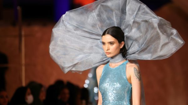 A model walks the catwalk at this year's Riyadh Fashion Week, a milestone in a country that used to require women to wear hijab headscarves and abaya robes in public