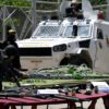 Venezuelan authorities show off the weapons they seized when they stormed the gang-held Tocoron jail with 11,000 police and soldiers