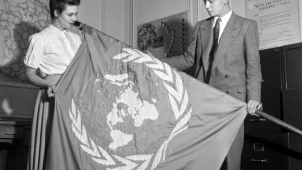 UN employees unfold a UN flag at the start of the third General Assembly of the United Nations in 1948 at the close of which was adopted on December 10 the Universal Declaration of Human Rights