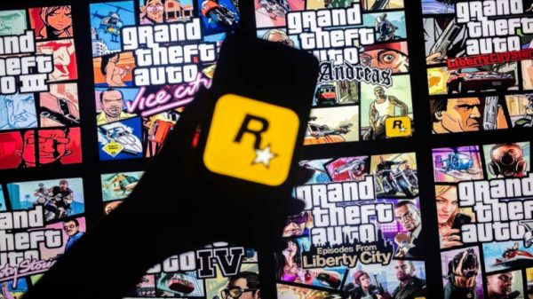 This illusttation shows a logo of Rockstar Games on a smartphone screen and covers of video game series Grand Theft Auto (GTA) on a TV screen in New York, November 27, 2023