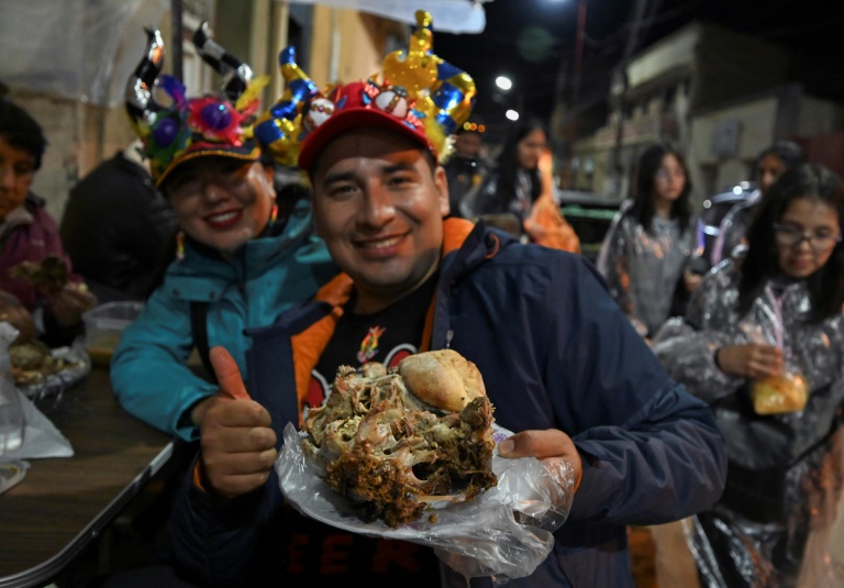 Customers brave the cold to queue up for their traditional sheep's head dish in Oruro