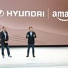 Amazon Vice President Marty Mallick (L) and Hyundai Global President Jose Munoz speak at the media preview day for the Los Angeles Auto Show, on November 16, 2023