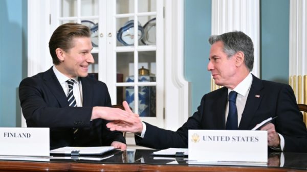 US Secretary of State Antony Blinken shakes hands with Finnish Defense Minister Antti Hakkanen during a ceremony for a defense cooperation agreement in the State Department's Treaty Room