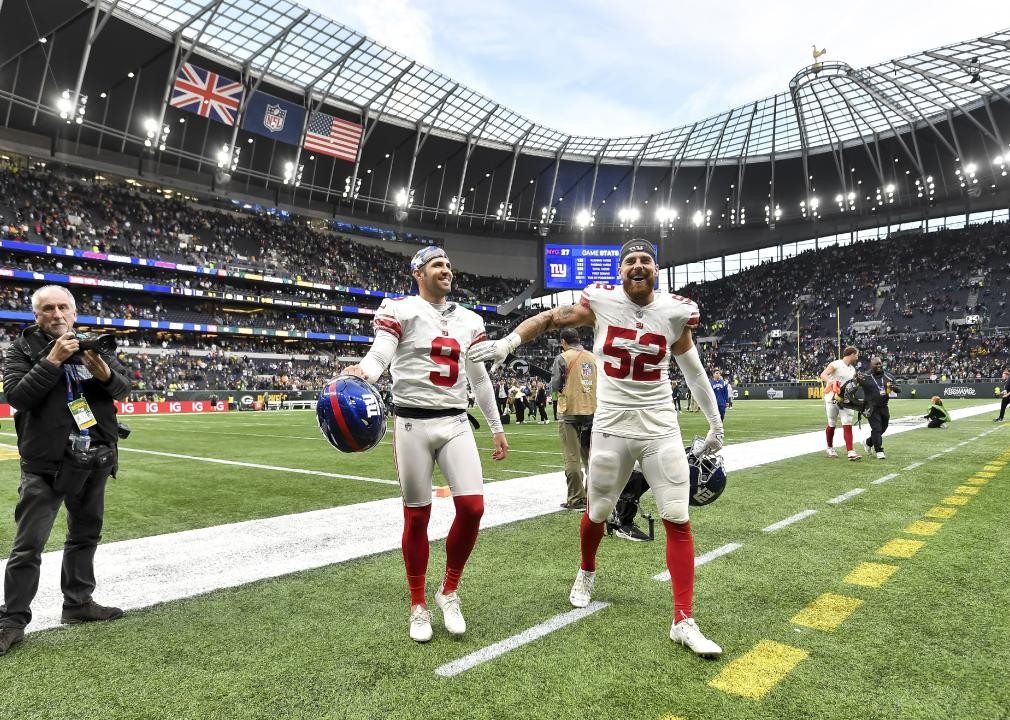 Graham Gano and Carter Coughlin of New York Giants celebrate at Tottenham Hotspur Stadium.