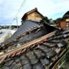 The earthquake left deep cracks in concrete and brought down entire wooden homes so only their tiled roofs lay on the ground