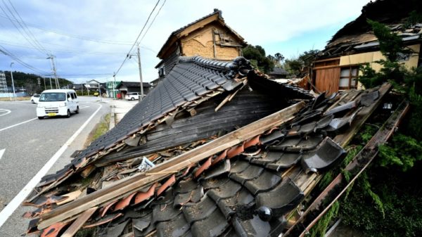 The earthquake left deep cracks in concrete and brought down entire wooden homes so only their tiled roofs lay on the ground