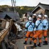 Firefighters inspect collapsed wooden houses in the city of Wajima on Japan's Noto Peninsula, the area hardest hit by the New Year's Day earthquake