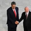 Venezuela's President Nicolas Maduro (L) and Brazilian President Luiz Inacio Lula da Silva shake hands during a welcome ceremony at the presidential palace in Brasilia