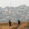 Israeli soldiers patrol along the Israel-Gaza border