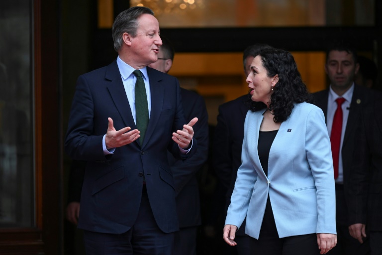 Britain's Foreign Secretary David Cameron (L) met with Kosovo President Vjosa Osmani in Pristina