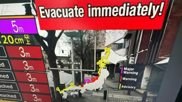 A video image taken in Hong Kong shows a warning message from a live feed on NHK World asking people to evacuate after a series of major earthquakes in central Japan prompted tsunami warnings