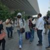 Passengers (C) arriving from France refused to speak to waiting journalists at Mumbai airport